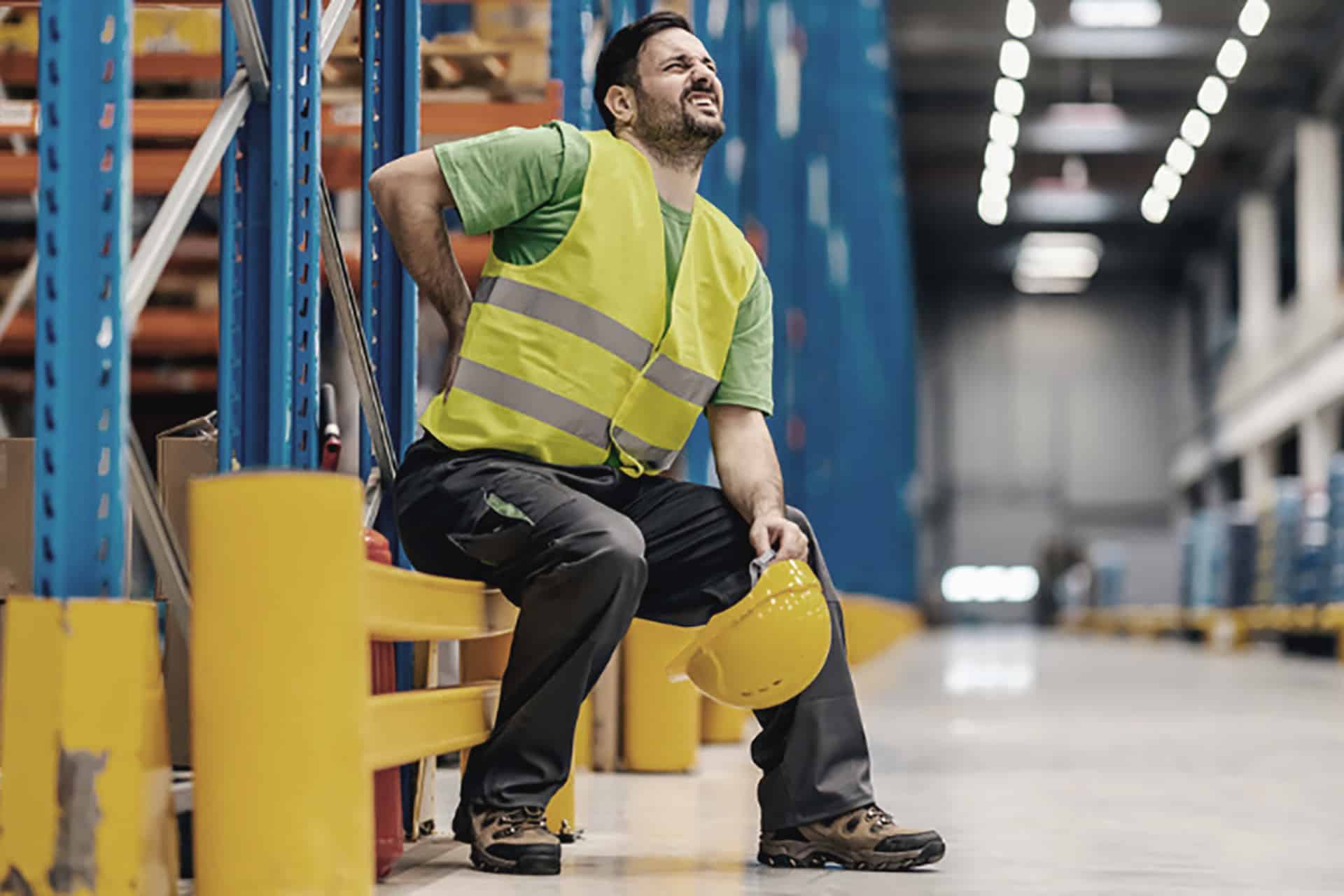 man with lower back injury at work